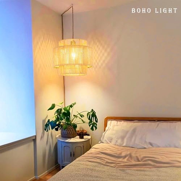 Woven rattan pendant light glowing in a cozy bedroom corner