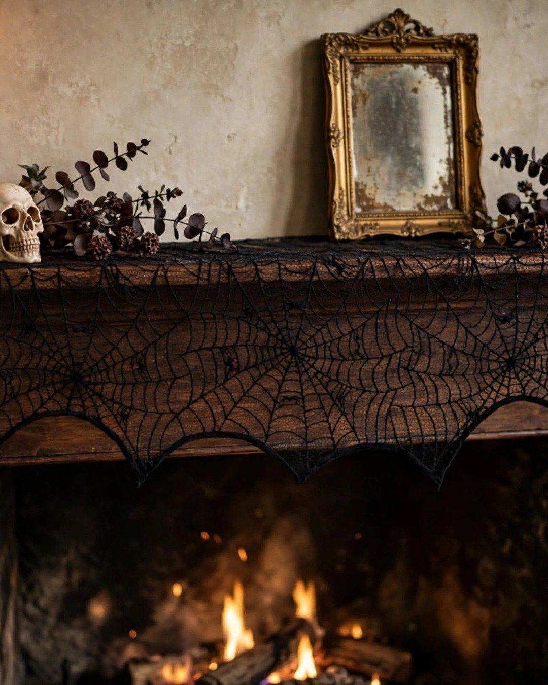 Black lace spiderweb mantel scarf draped over an elegant gothic Halloween mantel