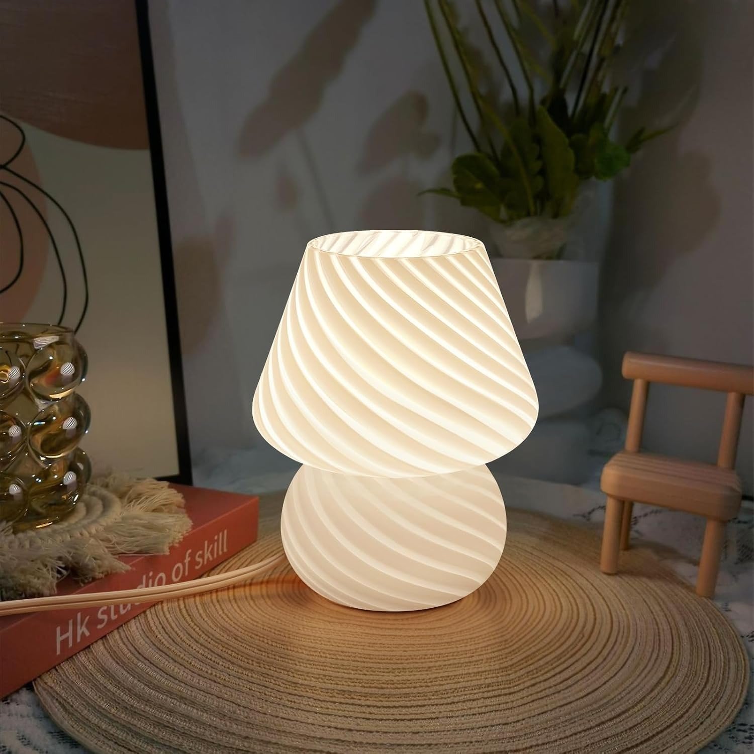 ONEWISH striped glass mushroom lamp with warm glow on a wooden bedside table